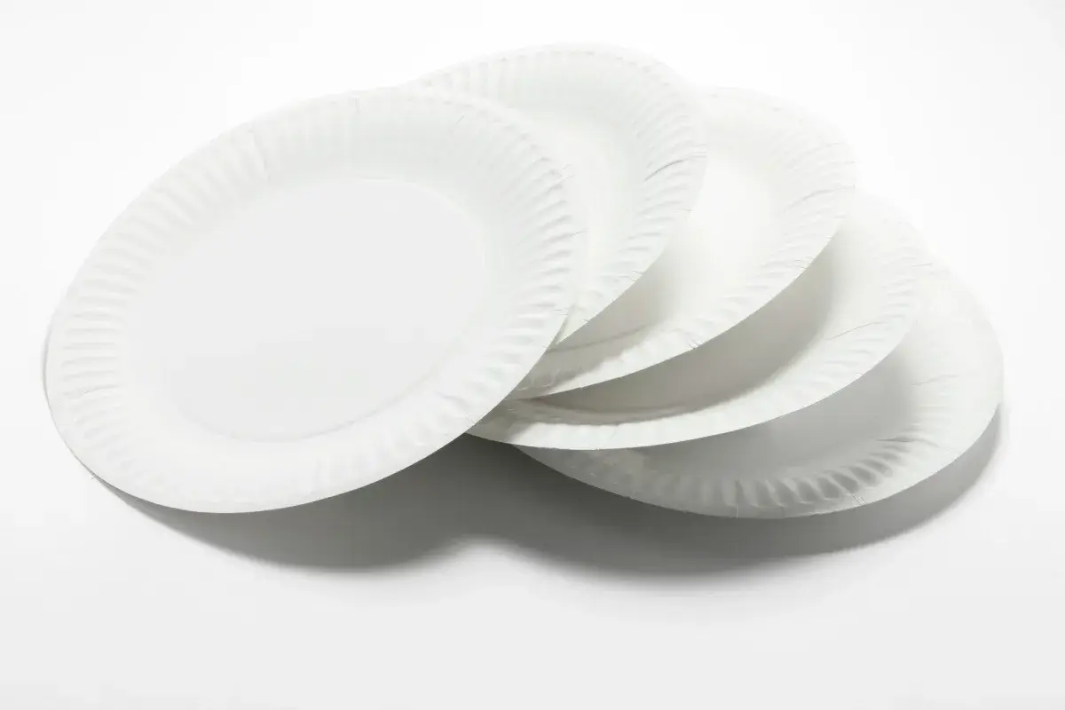 White paper plates on white table top